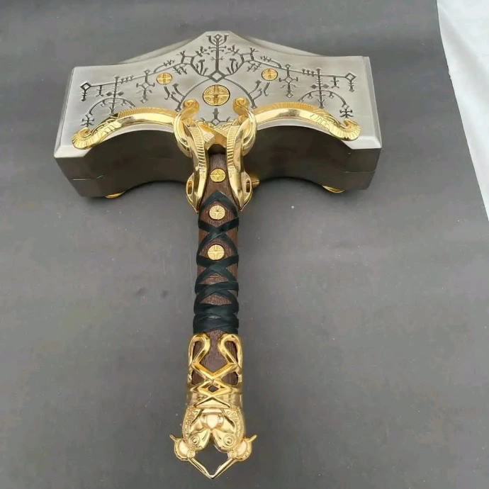 Hand-forged custom Viking hammer axe with detailed metal carving