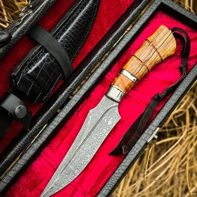 Custom handmade hunting knife with red handle and leather sheath